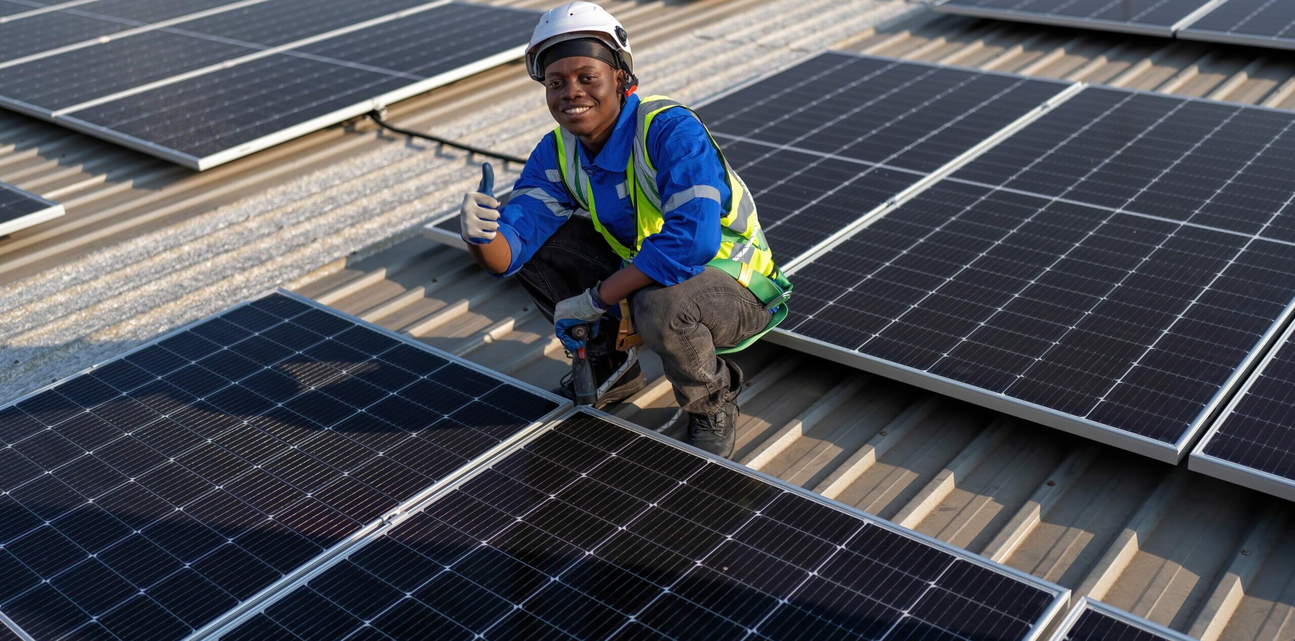 engineer-on-rooftop-sitting-next-to-solar-panels-p-2023-01-04-06-49-33-utc-min-scaled-e1679241972487